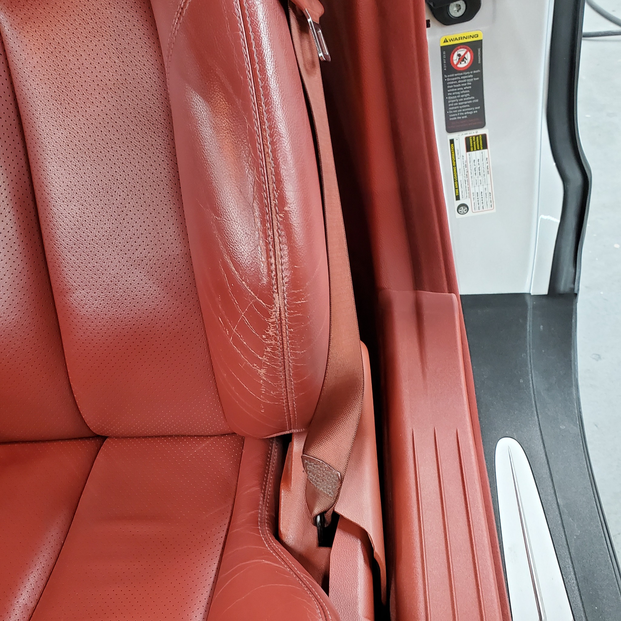 Red leather seat bolster before restoration